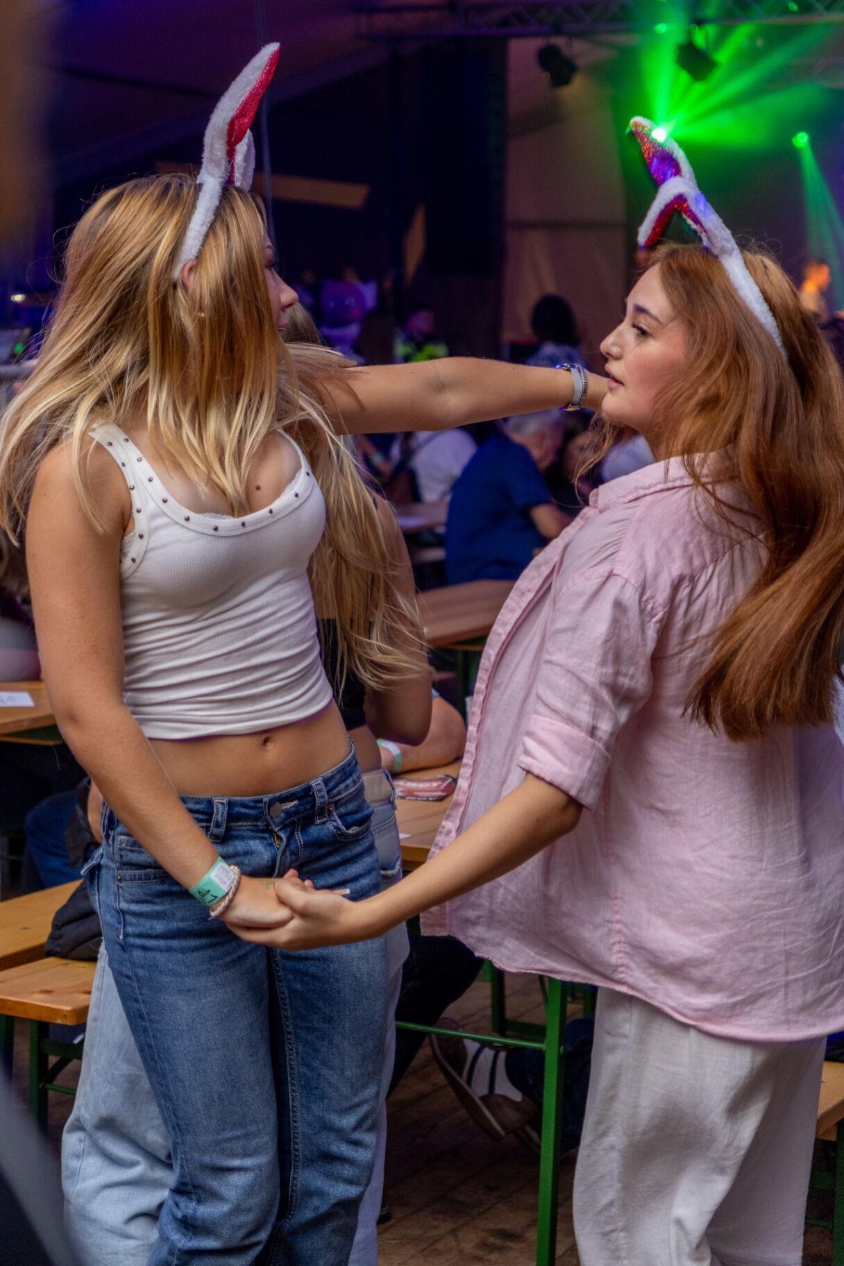 Zwei junge Frauen feiern ausgelassen auf einem Fest